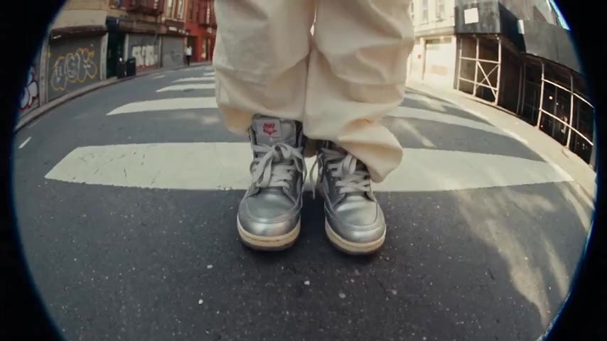 Original adult fashion model in white cargo trousers on a controlled urban set